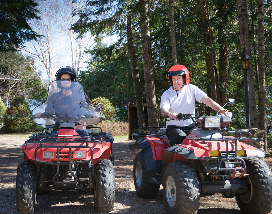 Young couple riding quad vehicles in Lake Arrowhead